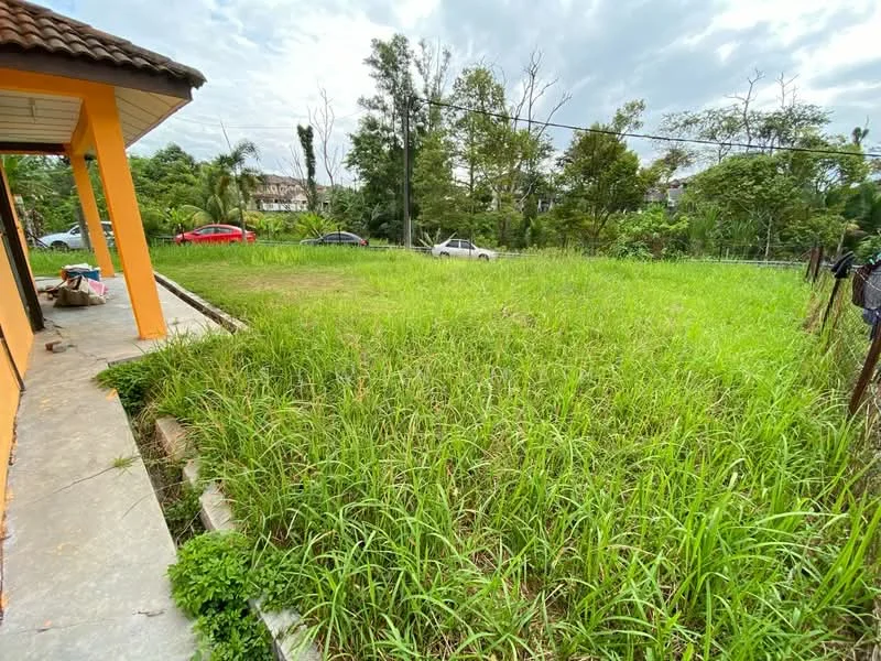 Exterior type: landscape garden; features: overgrown grass, surrounding trees, paved walkway, fenced perimeter, adjacent parking area, urban residential context.