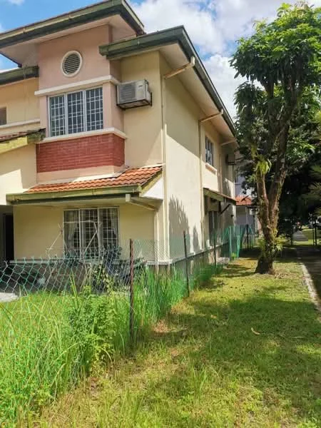 Exterior type: semi-detached house; features: cream painted facade, red brick accents, gabled roof, window air conditioning unit, fenced yard, manicured lawn, surrounding greenery, paved walkway, single-storey, front porch; style: traditional.
