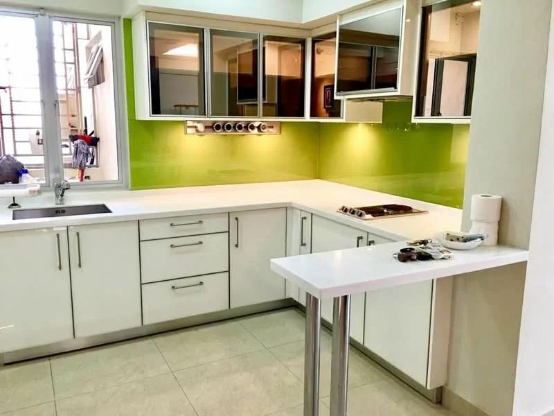 Kitchen features: white cabinetry with flat-panel doors, green glass backsplash, white quartz countertop, single-bowl stainless-steel sink, chrome pull-down faucet, built-in stove with hood, open shelving, tile flooring, large window for natural light, under-cabinet lighting, breakfast bar with white countertop, modern design; style: modern.