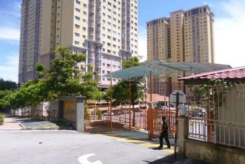 Exterior type: high-rise condominium; features: gated entrance, guard house at entrance, covered parking area, surrounded by mature greenery, multiple high-rise buildings, paved driveway, signage at entrance; style: modern.