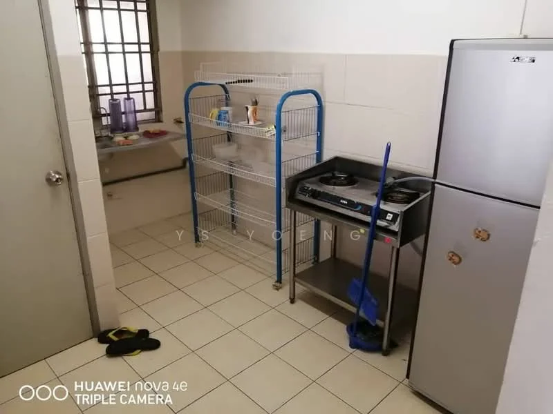 Kitchen features: white tiled walls, cream tiled flooring, stainless-steel fridge, 2-burner gas hob, metal shelving unit, sink, cleaning supplies, window with grid, broom, floor mat.
