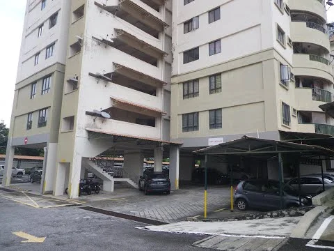 Exterior type: mid-rise condominium; features: multi-storey building, covered parking area, open-air parking lot, concrete facade, balconies on upper floors, staircase access, paved driveway, parking spaces marked, security gate at entrance; style: modern.