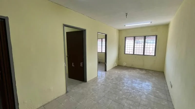 Room features: yellow painted walls, tile flooring, fluorescent ceiling light, two windows with grid pattern, single door, doorway leading to another room, bare walls with no decor, unfinished look.