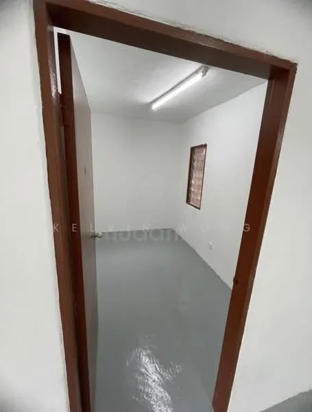 Room features: white painted walls, grey flooring, single window, flush door, ceiling light fixture, no visible furniture.