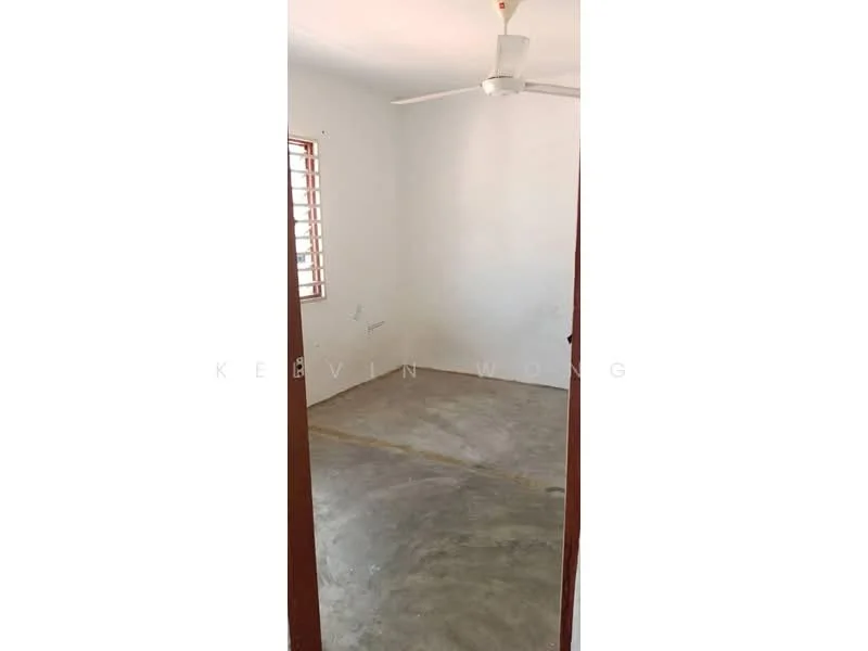 Room features: plain white walls, concrete flooring, ceiling fan, window with wooden grille, no visible furniture or decor; style: minimalist.