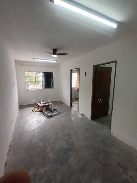 Room features: white painted walls, concrete flooring, ceiling fan, window with grille, doorway to adjacent room, doorway to hallway, light fixtures on ceiling, unfinished space with debris.