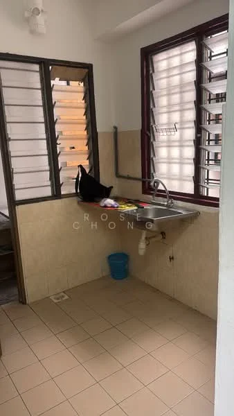 Room features: single-bowl stainless-steel sink, chrome faucet, tile backsplash, cream tiled walls, light brown tiled flooring, window with horizontal slats, open shelving, plastic laundry basket.