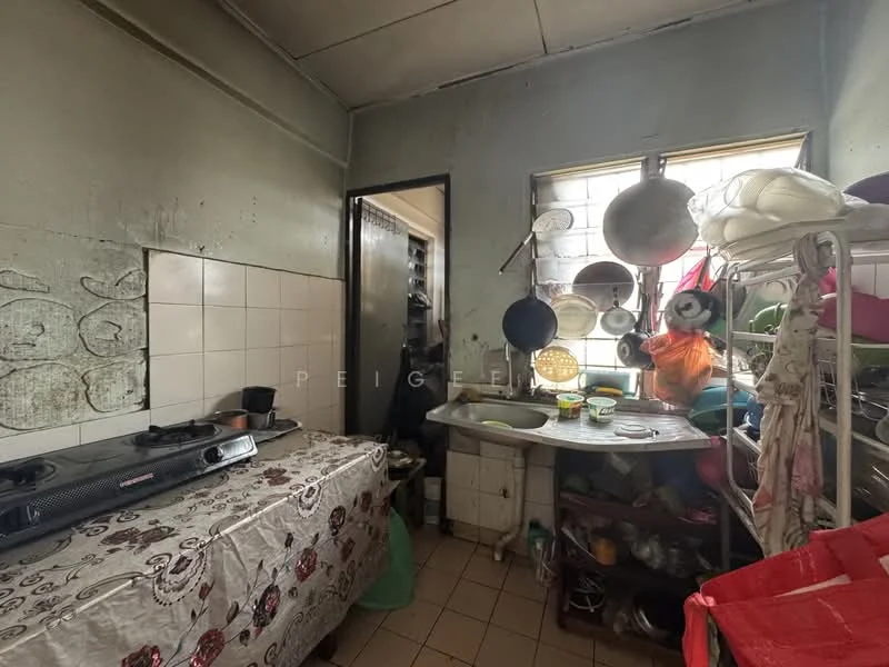 Kitchen features: white tiled walls, grey painted walls, ceramic tile flooring, single-bowl stainless-steel sink, chrome pull-down faucet, gas stove with two burners, open shelving, wooden cabinet, various pots and pans hanging, kitchen utensils on countertop, window with natural light.
