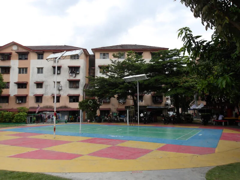 Exterior type: low-rise apartment block; features: basketball court, colored pavement, surrounding greenery, multiple storeys, balconies on upper floors, trees providing shade; style: modern.