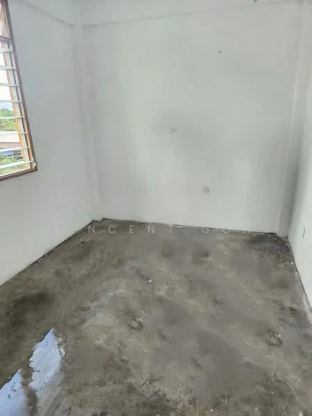 Room features: white painted walls, concrete flooring, window with wooden frame, natural light from window.