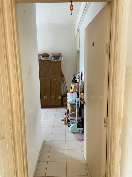 Room features: white walls, tile flooring, wooden storage cabinet, cleaning equipment, vacuum cleaner, broom, mop, various boxes, light source from ceiling.