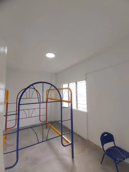 Room features: white painted walls, concrete flooring, ceiling light, window with horizontal bars, colorful play structure, blue plastic chair; style: modern.