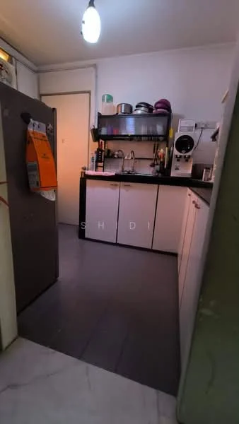 Kitchen features: grey tile flooring, white cabinetry, black countertop, stainless-steel sink, chrome pull-down faucet, built-in coffee machine, freestanding fridge, open shelving, wall-mounted storage rack, kitchen utensils visible, light fixture, window for natural light; style: modern.