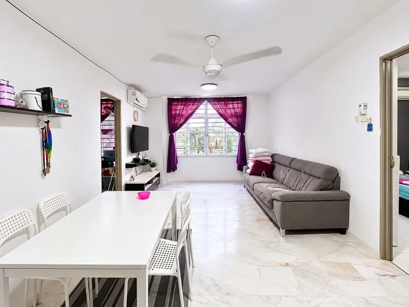 Living features: 3-seater fabric sofa in grey, white walls, marble flooring, ceiling fan, floor-to-ceiling window, purple sheer curtains, TV console, wall-mounted TV, decorative wall art, open shelving, area rug; style: modern; view: garden. Dining features: 6-seater dining table in white, plastic dining chairs, decorative bowl on table; style: modern.