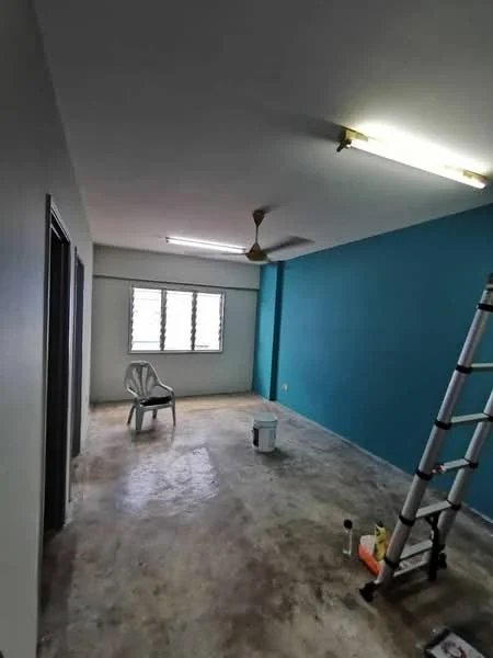 Room features: blue accent wall, white painted walls, concrete flooring, ceiling fan, fluorescent ceiling lights, window with horizontal slats, plastic chair, ladder, paint bucket, paint supplies; style: modern.