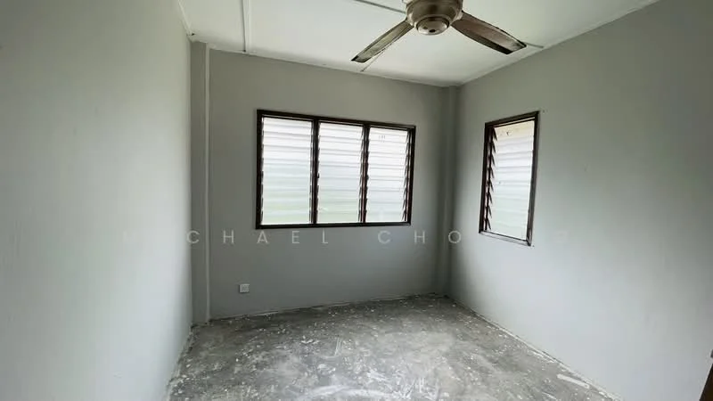 Room features: grey painted walls, concrete flooring, 2 windows with horizontal slats, ceiling fan.