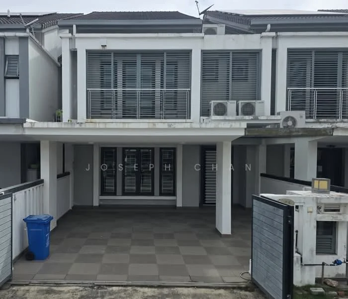 Exterior type: linked terrace house; features: two-storey building, grey painted facade, horizontal slatted window shutters, balcony with railing, visible air conditioning units, paved outdoor area, blue recycling bin, fenced perimeter, driveway, manicured landscaping; style: modern.