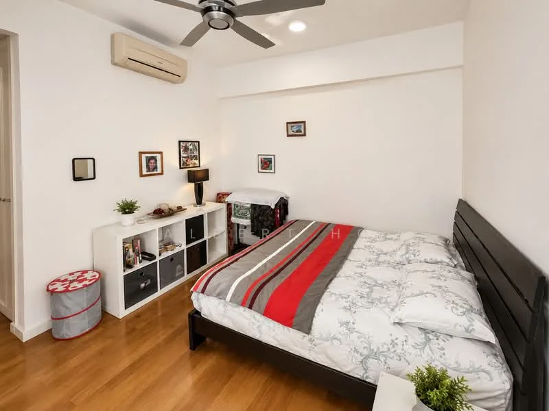 Bedroom features: king-size bed with grey headboard, bedding with floral pattern, wooden flooring, 1 wall-mounted split AC, ceiling fan with light, nightstand with lamp, framed artwork on walls, open shelving unit, decorative storage box, white painted walls; style: modern.