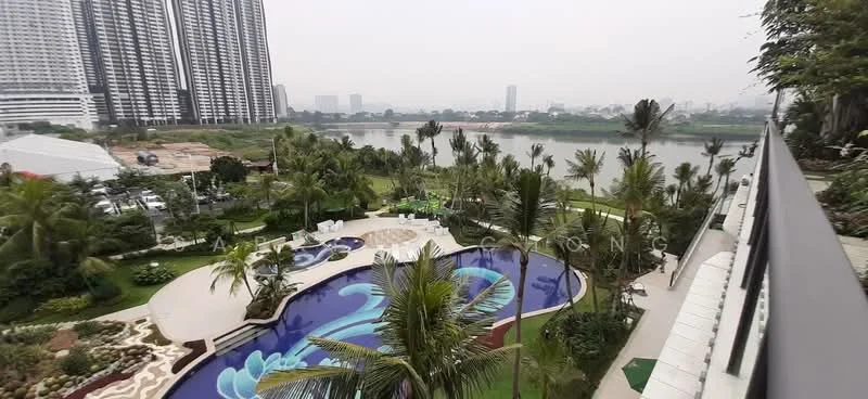 Exterior type: high-rise condominium; features: infinity pool, landscape garden, manicured lawn, palm trees, children's playground, jogging track, waterfront view, surrounded by greenery, multi-storey high-rise, pool deck with loungers; style: modern.