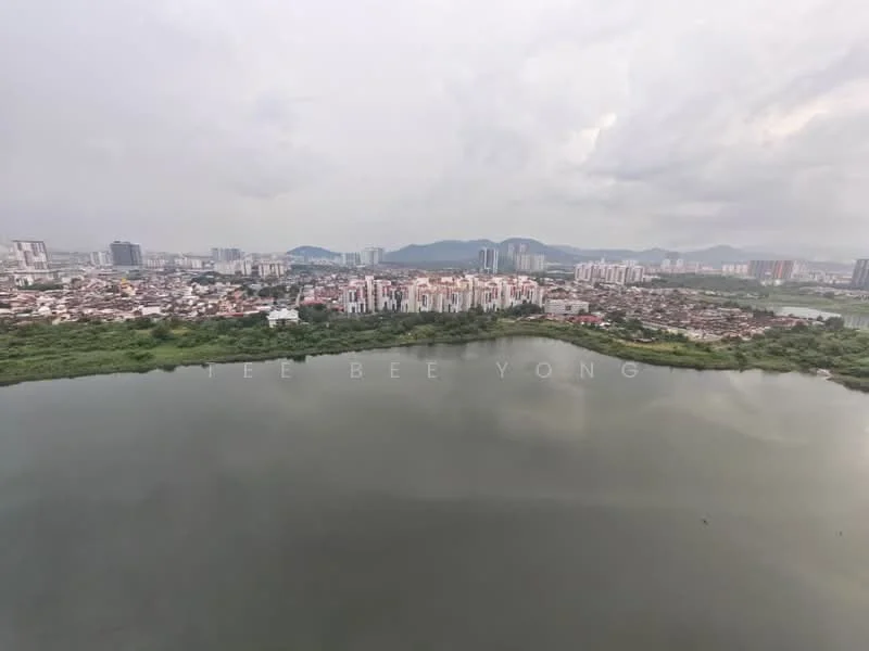 Exterior type: high-rise condominium; features: waterfront view, city skyline in background, surrounded by greenery, urban landscape, multi-storey buildings, lake or river, cloudy sky; style: modern.
