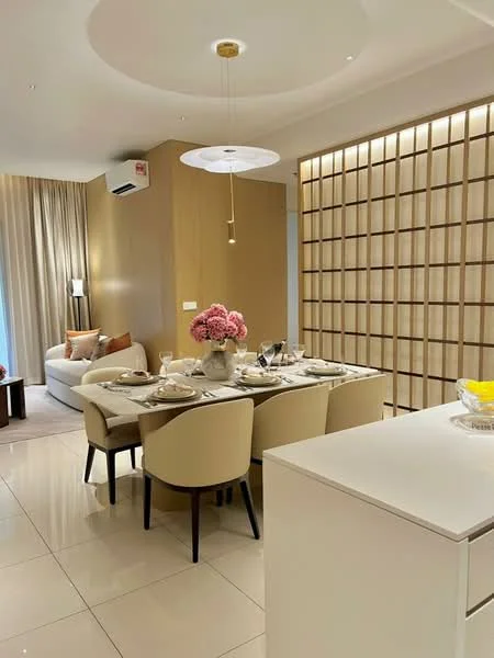 Dining features: round dining table, upholstered dining chairs, table setting with plates and cutlery, decorative vase with pink flowers, pendant light fixture, cream painted walls, white cabinetry, marble tile flooring, recessed ceiling lights, wall paneling with wood accents, floor-to-ceiling curtains; style: modern. Living features: fabric sofa, side table, table lamp, decorative cushions; style: modern.