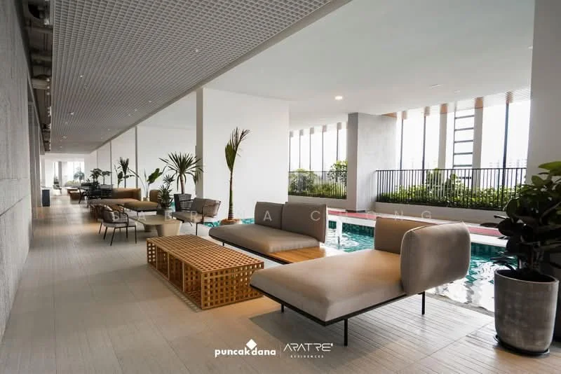 Room features: indoor swimming pool, lounge chairs, outdoor seating area, wooden coffee table, potted plants, large windows, poolside deck, concrete flooring, modern lighting fixtures, open layout; style: modern; view: city.
