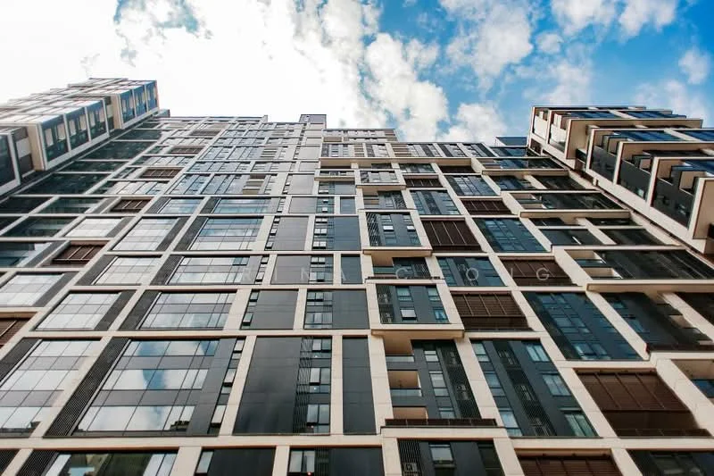 Exterior type: high-rise condominium; features: glass curtain wall, black and white facade, recessed balconies, large windows, multiple storeys, modern architectural design; style: modern.