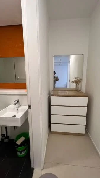 Bathroom features: wall-mounted sink, chrome faucet, mirror above sink, wooden cabinet with drawers, white cabinetry, orange accent wall, neutral wall colour, tile flooring, decorative vase on cabinet; style: modern.