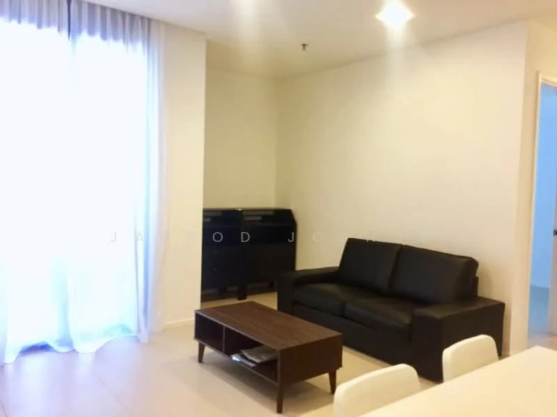 Living features: black leather sofa, wood coffee table, light-colored walls, large window with sheer curtains, tile flooring, recessed ceiling lights, sideboard or console table, neutral decor; style: modern.