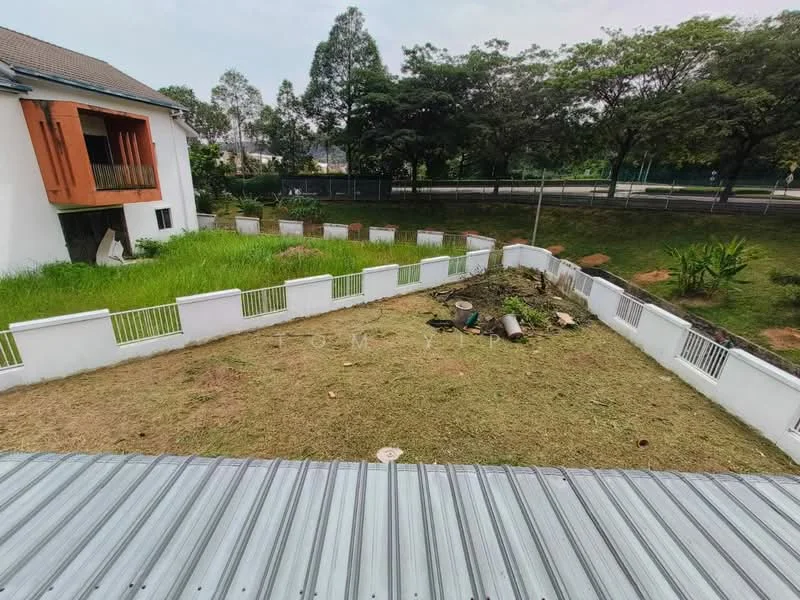 Exterior type: detached bungalow; features: manicured lawn, fenced yard with white railing, landscaped garden area, paved pathway, surrounding mature trees, adjacent to main road; style: modern.