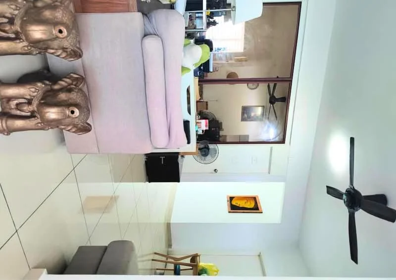 Living features: light-colored fabric sofa, 2 decorative elephant sculptures, ceiling fan, wall-mounted artwork, tile flooring, large window with natural light, wooden furniture, open layout; style: modern.