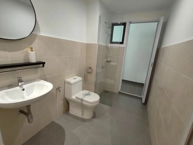 Bathroom features: single-sink vanity with wall-mounted faucet, framed mirror, one-piece toilet, walk-in shower with glass enclosure, chrome shower head, tile cladding on walls, grey floor tiles, black shelf above sink; style: modern.