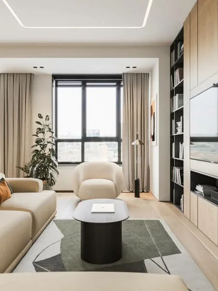 Living features: beige fabric sofa, round coffee table with black base, green area rug with geometric pattern, floor-to-ceiling windows, sheer curtains, built-in shelving unit, wall-mounted TV, decorative artwork on wall, indoor plant, modern floor lamp, light wood flooring, recessed ceiling lights, neutral wall colour; style: modern; view: city.