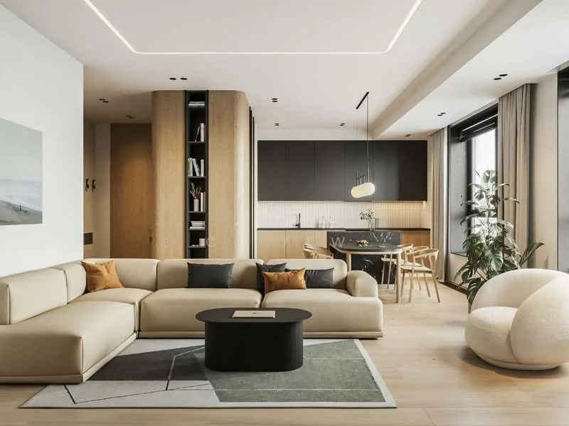 Living features: L-shape sectional sofa in beige, round black coffee table, area rug with geometric pattern, floor-to-ceiling windows, wooden flooring, recessed LED downlights, decorative wall art, potted indoor plant, neutral wall color, open layout to kitchen, ceiling with integrated LED lighting; style: modern. Kitchen features: black cabinetry, white tiled backsplash, wooden dining table with chairs, pendant light fixture, open shelving, stainless-steel appliances, kitchen island, neutral color palette; style: modern.