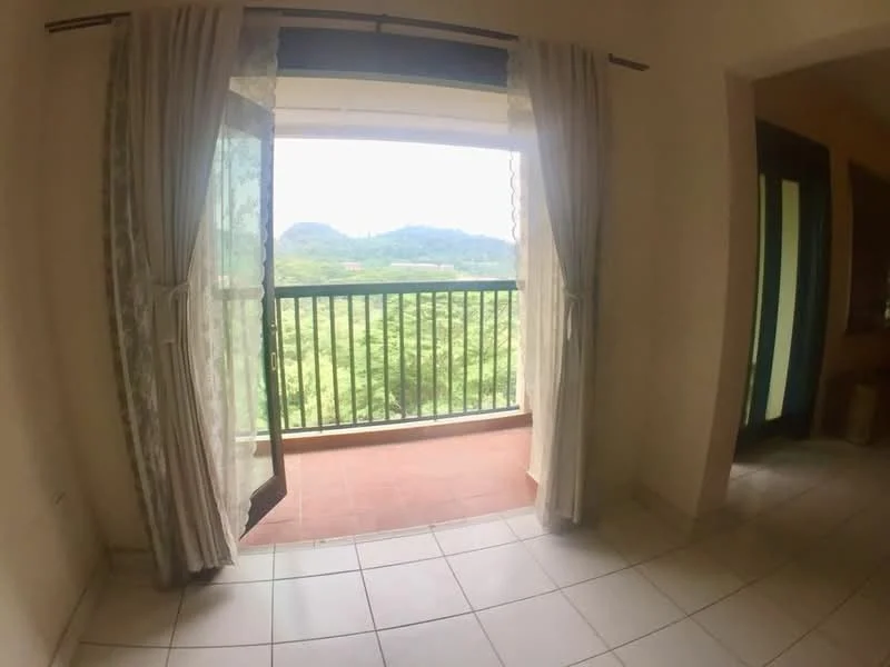 Room features: sliding glass door, curtains, tile flooring, balcony with railing, view of greenery, light-colored walls; view: garden.