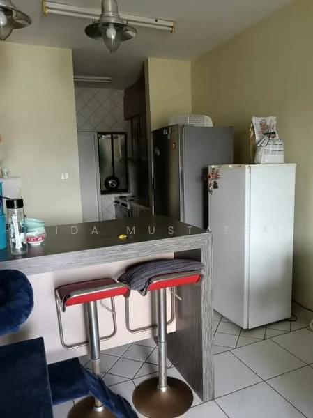 Kitchen features: grey laminate countertop, stainless-steel fridge, white fridge, bar stools with red upholstery, white tiled flooring, cream painted walls, kitchen island, built-in cabinets, recessed lighting, open layout to living area; style: modern.