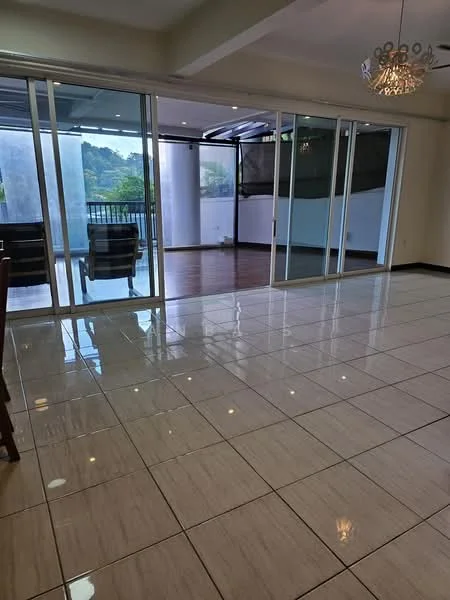 Living features: glossy ceramic tile flooring, floor-to-ceiling sliding glass doors, recessed downlights, chandelier, open layout, access to balcony, neutral wall color, large windows, view of greenery; style: modern; view: garden.