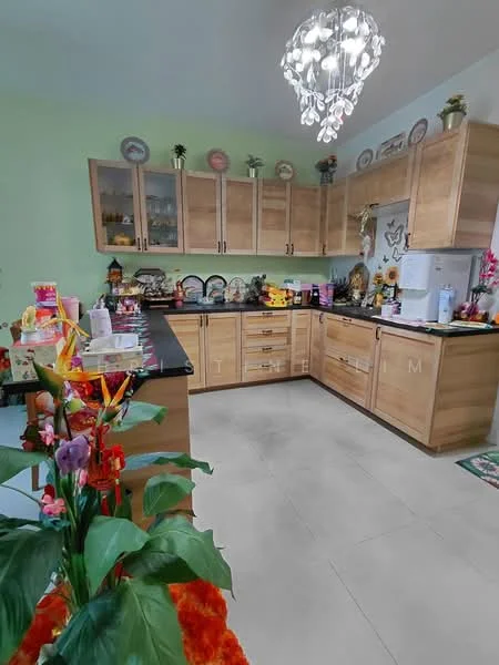 Kitchen features: wood cabinetry, black countertop, ceramic tile flooring, chandelier light fixture, built-in refrigerator, microwave, decorative plates on shelves, kitchen utensils on countertop, flower arrangement, green painted walls, open shelving, sink, stainless-steel faucet; style: modern.