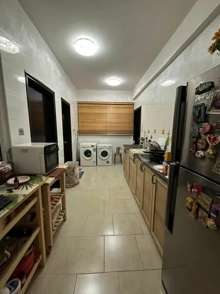 Kitchen features: white tiled walls, cream cabinetry, stainless-steel refrigerator, built-in oven, microwave, double-bowl stainless-steel sink, chrome pull-down faucet, countertop with decorative items, washing machine, tumble dryer, overhead lighting, tile flooring; style: modern.