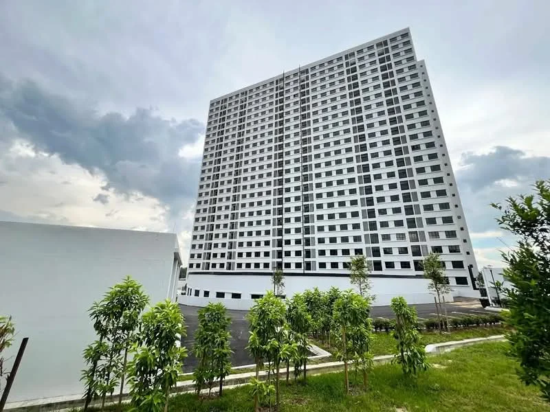 Exterior type: high-rise condominium; features: white painted facade, glass windows, approximately 15-storey high-rise, surrounded by landscaped greenery, parking area visible, modern architectural design; style: modern.
