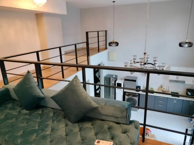 Living features: sofa with tufted upholstery in teal, metal railing, wooden flooring, chandelier with multiple bulbs, pendant lights, open-plan layout, white walls, kitchen area visible, stainless-steel appliances, kitchen cabinetry in dark grey; style: modern.