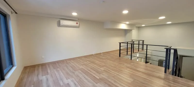 Room features: laminate flooring, white painted walls, recessed downlights, 1 wall-mounted split AC, large window, metal railing, open space layout; style: modern.