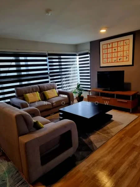 Living features: 3-seater fabric sofa in grey, 2-seater fabric sofa in grey, green accent cushions, black coffee table, TV console with storage, wall-mounted TV, area rug with geometric pattern, large windows with black horizontal blinds, wooden flooring, decorative wall art, indoor plant; style: modern.