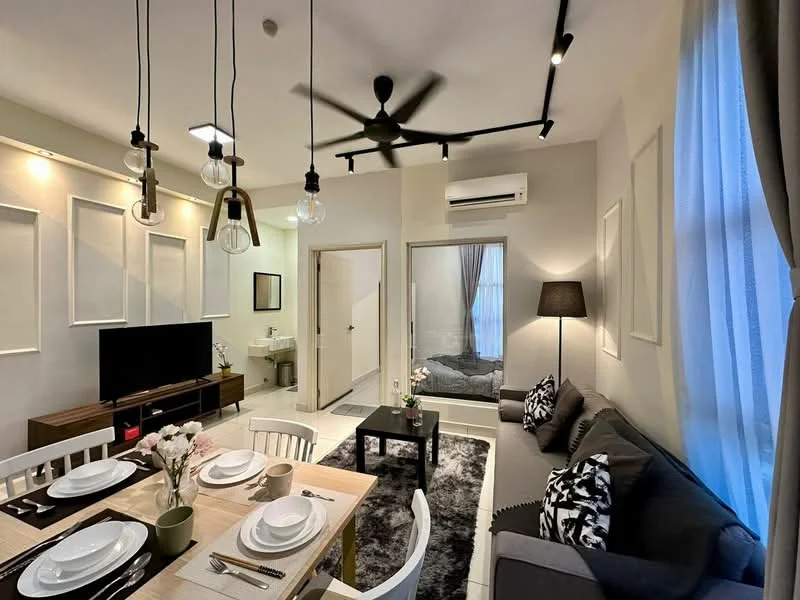 Living features: 3-seater fabric sofa in grey, 2-seater dining table with white chairs, pendant lighting with exposed bulbs, wall-mounted TV, black floor lamp, area rug with geometric pattern, ceiling fan with light, wall-mounted air conditioning unit, decorative wall panels, curtains in light fabric, coffee table, decorative vase with flowers; style: modern. Room features: doorway leading to another room, light-colored walls, white painted ceiling, grey bedding visible in adjacent room.