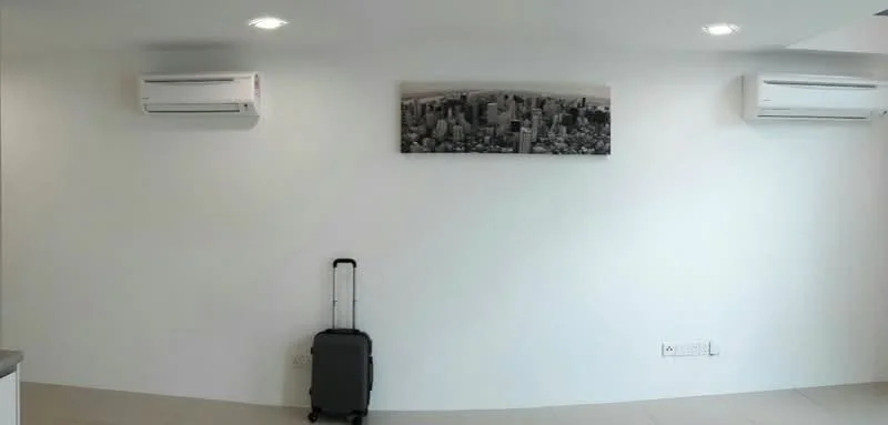 Room features: white painted walls, 2 wall-mounted split ACs, light-colored tile flooring, framed artwork on wall, suitcase, recessed downlights; style: modern.