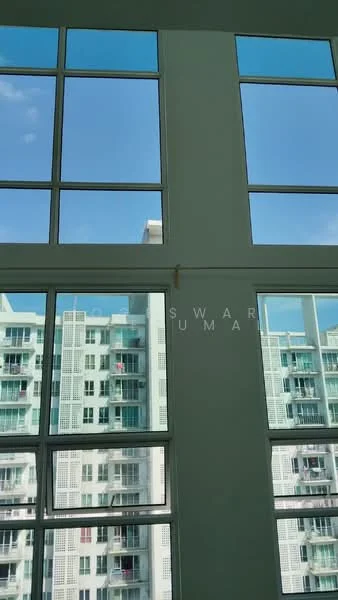 Room features: large floor-to-ceiling windows, white painted walls, natural light, view of adjacent building, blue sky, grid pattern window design; style: modern; view: city.