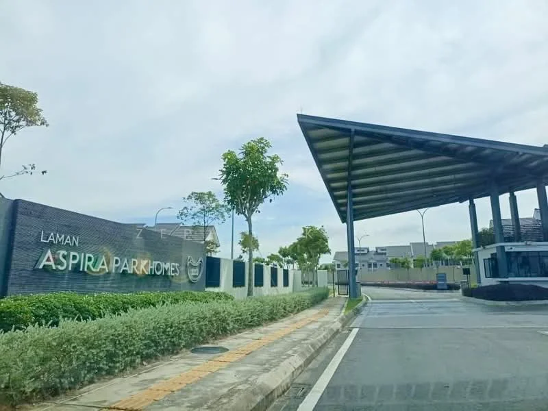 Exterior type: gated community; features: signage with 'Aspira Park Homes', landscaped entrance with shrubs, paved driveway, covered entrance with modern roof, security booth, surrounding greenery, street lighting, curved road leading into the community; style: modern.