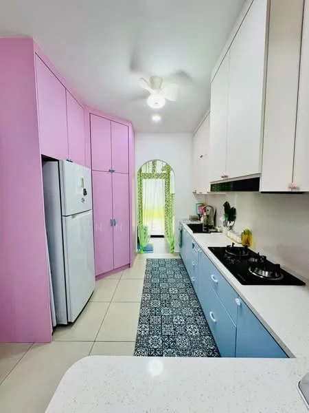Kitchen features: pink cabinetry, blue cabinetry, white countertop, stainless-steel fridge, built-in gas hob, exhaust hood, pendant light, ceramic tile flooring, decorative area rug, window with sheer curtains, green patterned curtains, open layout; style: modern.