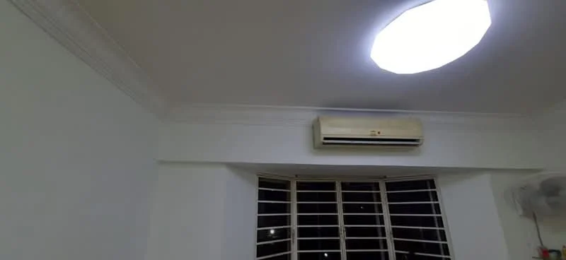 Room features: white painted walls, ceiling with crown moulding, 1 wall-mounted split AC, recessed ceiling light, window with multiple panes.