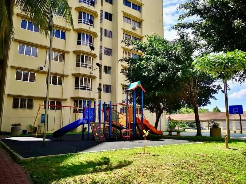 Exterior type: low-rise apartment block; features: playground with slides and climbing structures, manicured lawn, mature trees, basketball court, paved walkway, yellow painted facade, multiple windows, surrounding greenery; style: modern.